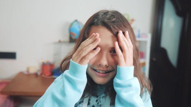 peek a boo. little girl covered her eyes face with her hands hide-and-seek waiting for a surprise. slow motion video. teen lifestyle girl playing bo-peep. childhood concept game hy - spy