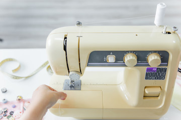 female hands are using a sewing machine