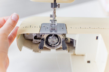 female hands are using a sewing machine