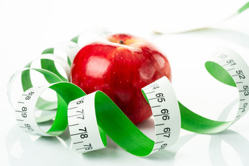 tape measure and red apple