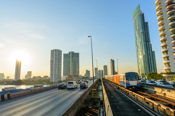 Fototapeta na wymiar blur light of car traffic and sky train in city