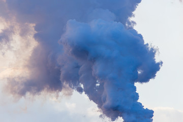 Smoke from pipes in a factory pollutes nature