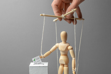 Elections and voting a person puts ballot paper in a box. Manipulation and corruption in the...