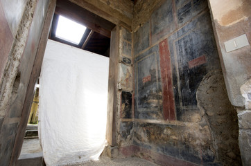 Painted walls of a house ruin at Roman city Pompei, Naples / Italy