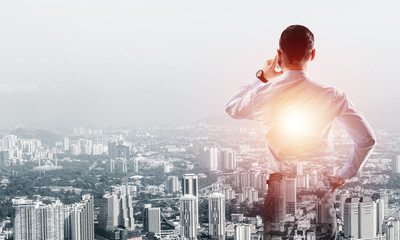 Concept of business success and control with confident boss against cityscape background