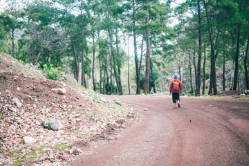 Fototapeta premium A man with a backpack is on a mountain road
