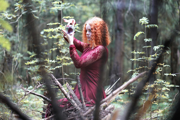 The red-haired witch holds a ritual with a crystal ball