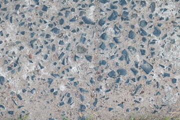 Concrete floor with a mixture of black stone and sand.