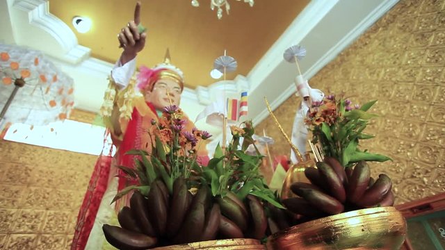 Focus and Panning Offering in Foreground with Rohani Bo Bo Gyi is believed to be the guardian spirit of Botahtaung Pagoda 