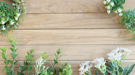 Middle Space on Wooden Board Among Flower and Green Plant 