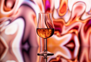 A glass of whiskey on an abstract background
