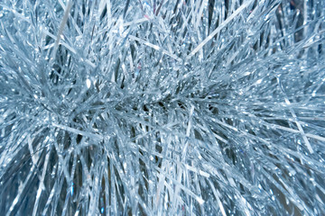 Christmas background with shiny silver tinsel closeup, also may be used as texture