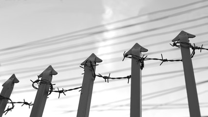Barbed Wire Surround Steel Arrow and High Fence, Look at Sky, Detained and No Freedom Symbol
