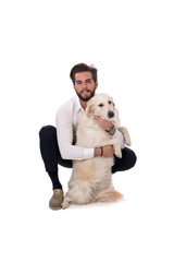 Handsome young man with labrador white dog, on white background in studio