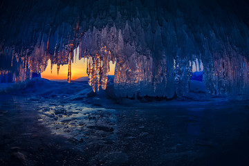 sunset in a cave grotto with icicles in the winter on Olkhon Island, Lake Baikal