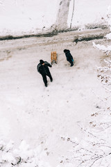 man and boy walking in snow
