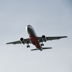 A passenger plane flies in the sky close up.