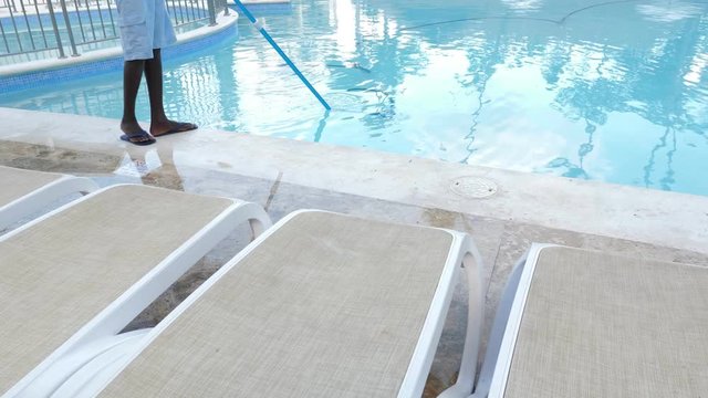 Man cleaning swimming pool