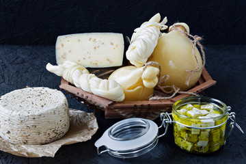 Different types of cheese on a black background. Cheese platter