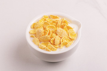 Fresh corn flakes in bowl with milk