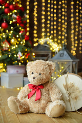 Teddy bears siting under the christmas tree with presents