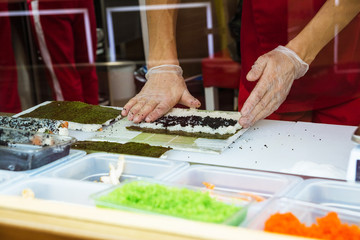 Obraz na płótnie Canvas Sushi making at a fast food restaurant