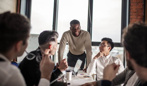 African american business couch provides to a multiracial group of employees corporate training, Stress and work-life issues were integrated into the corporate learning plan.
