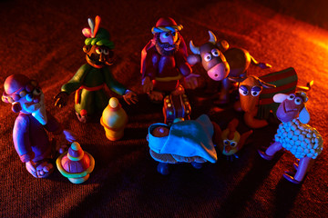 many plasticine figures on the theme of Christmas with beautiful lighting