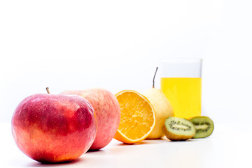 different fruit and juice or smoothie in a glass