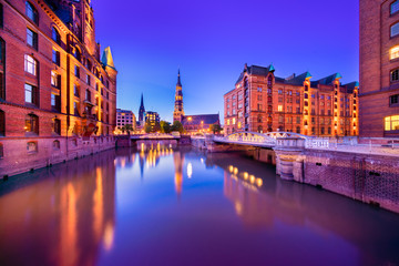 The Warehouse District (German: Speicherstadt) in Hamburg, Germany at night.  The largest warehouse...