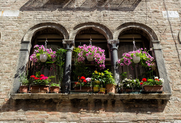 Fototapeta na wymiar Flowery balcony on a Venice building