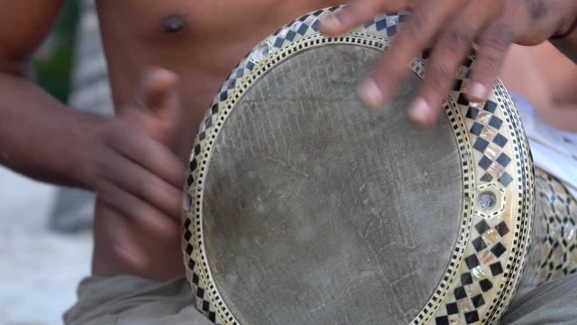 Man playing on a Bongo drum close up. Hand tapping a Bongo drum in close up.  Drummer hands, movement, rhythm.  Koh Phangan island, Thailand
