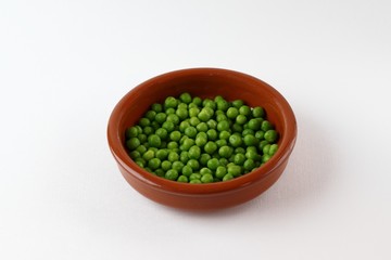 DISH MADE OF BRAISED CLAY  FULL OF GREEN PEAS