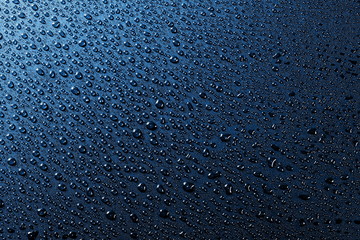 Obraz premium Water droplets on blue background and texture