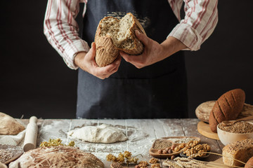 So, break bread with me. Cropped view of male Chef breaking freshly Baked Sourdough Bread, focus on...