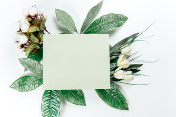 green sticky note with green plant leaves