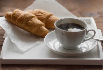 rustic Breakfast with croissants, black coffee and jam