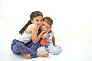 Siblings sitting of cute asian girl