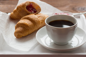 rustic Breakfast with croissants, black coffee and jam