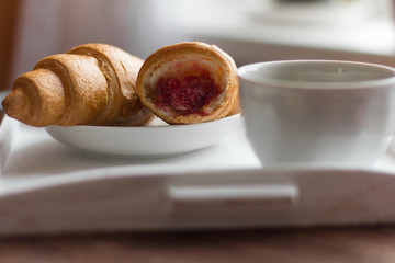 croissants with raspberry jam and black coffee