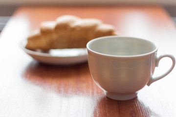 coffee Cup and croissant on the table