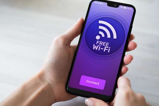 Free wifi connection on mobile phone screen. Internet and telecommunication technology concept.
