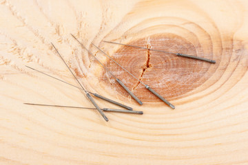 Table with needles for acupuncture. Silver needles for traditional acupuncture medicine on table.