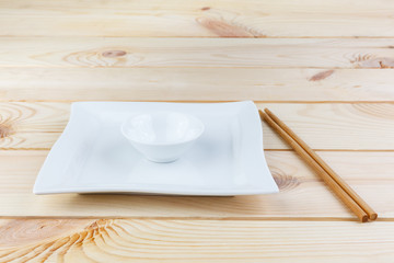 Wooden Chopsticks and cups on blackboard Japanese and Chinese food equipment.With copy space