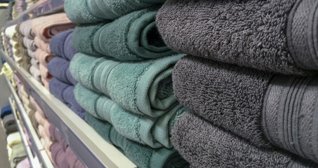 Towels on the counter of the store, a large assortment of colors