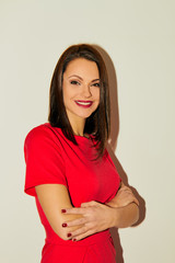 Portrait of beautiful smiling woman looking at camera over white background.