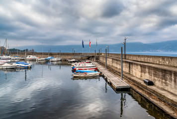 Fototapeta premium New Harbor of Luino on the Lake Maggiore in cloudy day, province of Varese, Italy