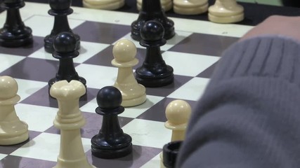 FOCUSING CHILD’S HAND PLAYING CHESS