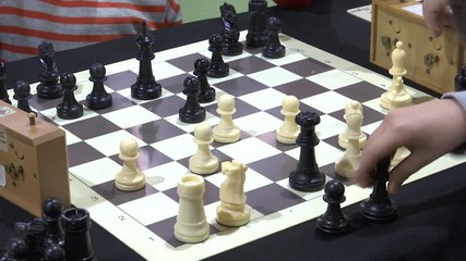 FOCUSING CHILD’S HAND PLAYING CHESS