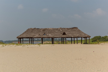 pondicherry india October 27 2018 Paradise beach view photographed inside from bamboo hut.low light photography with selective focus on the subject.people seen hanging out with friends and family